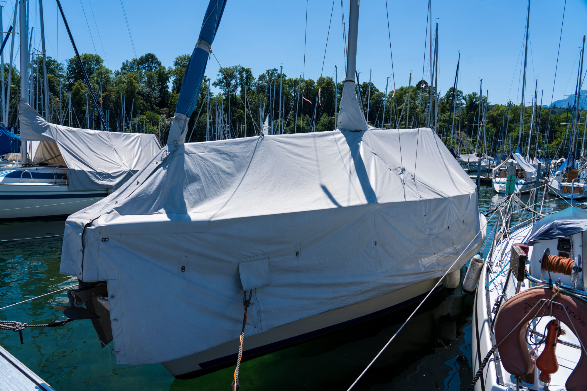Segelboot im Hafen mit weißer Abdeckung
